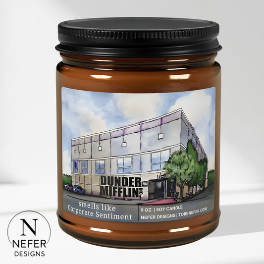 Candle jar with a label featuring 'Dunder Mifflin' building and Nefer Designs logo.