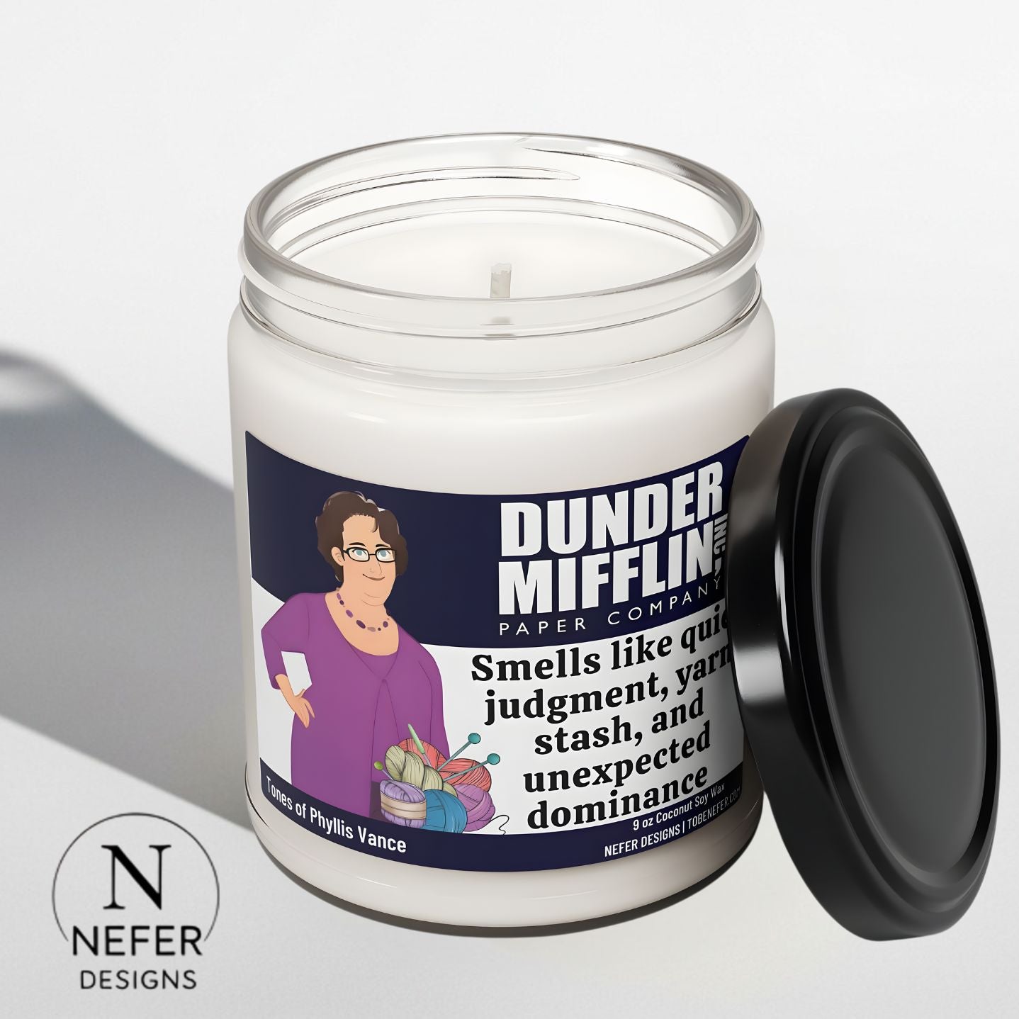 Candle in a jar with a Phyllis Vance label from 'Dunder Mifflin' on a light gray background