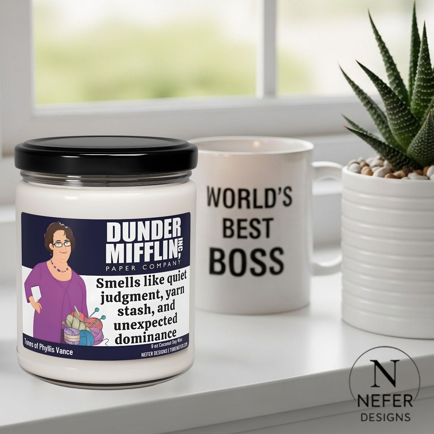 Jar and mug with 'Dunder Mifflin' branding on a surface with a plant in the background