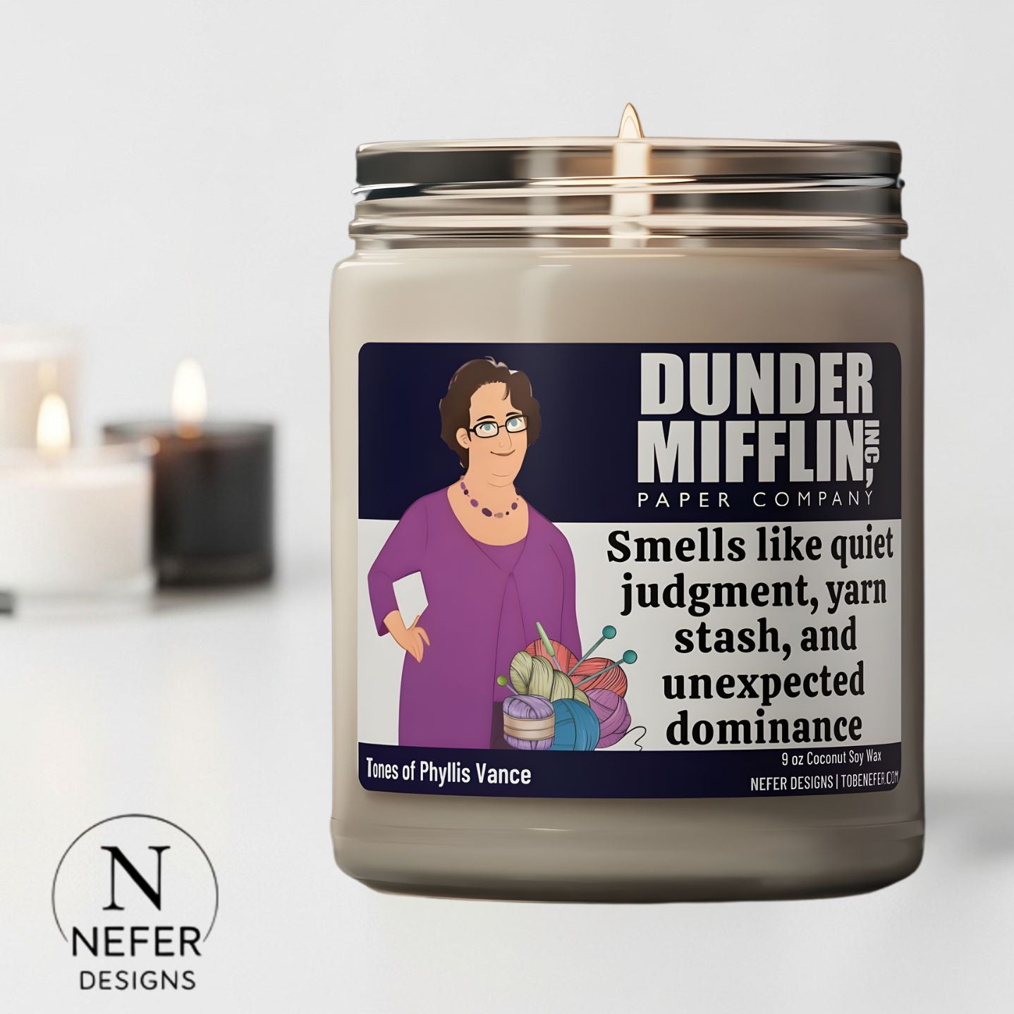 Candle with a label featuring an illustration of a character from 'The Office' and text about its scent.
