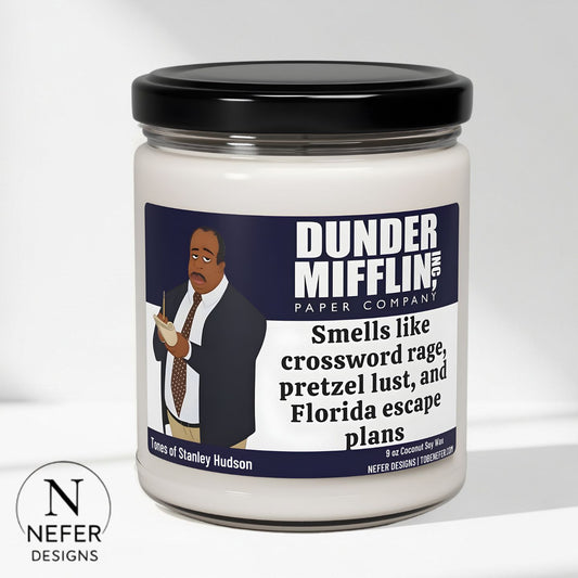Candle with a label featuring Dunder Mifflin branding and a humorous description.