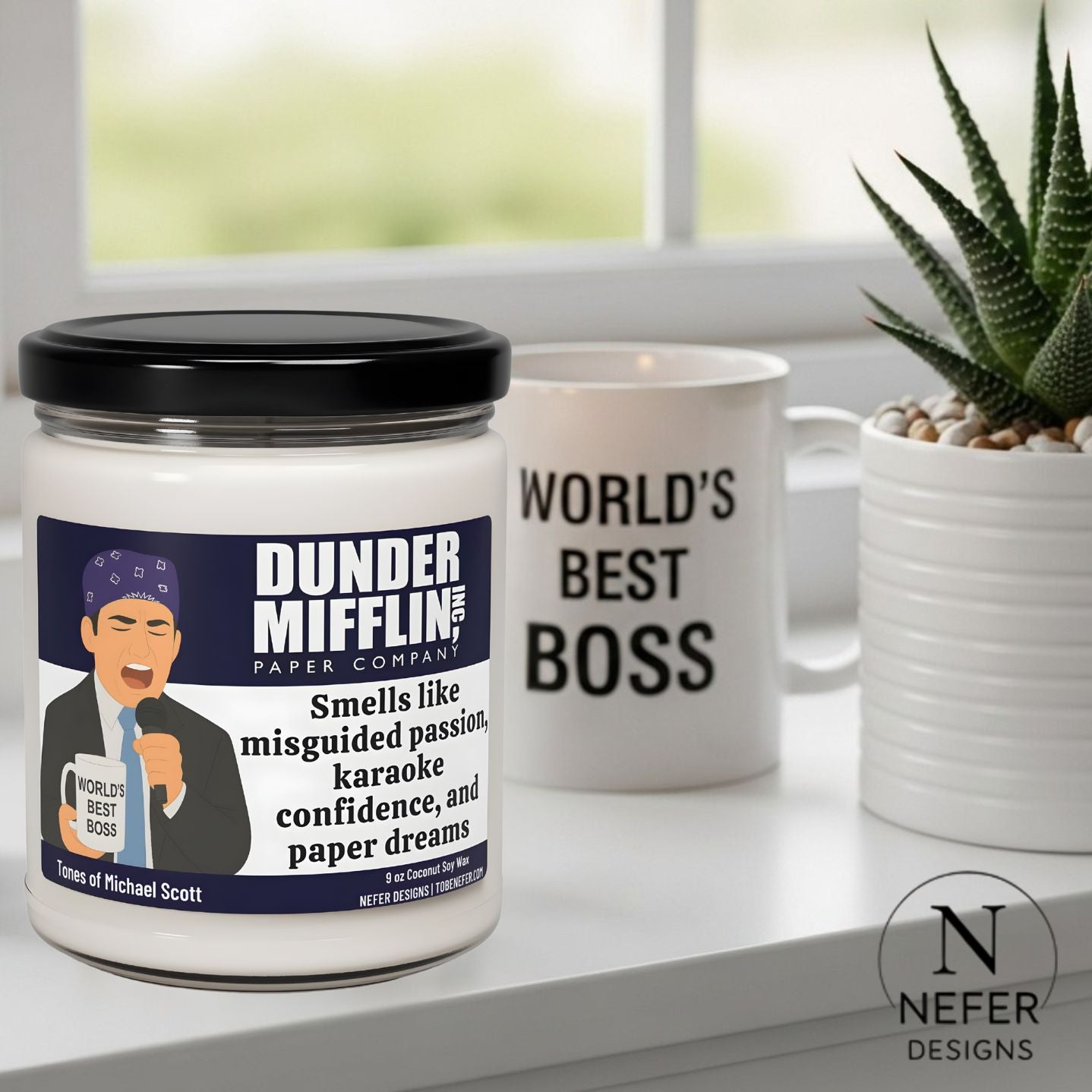 Jar labeled 'Dunder Mifflin' with a humorous label and a mug with 'World's Best Boss' text on a windowsill.