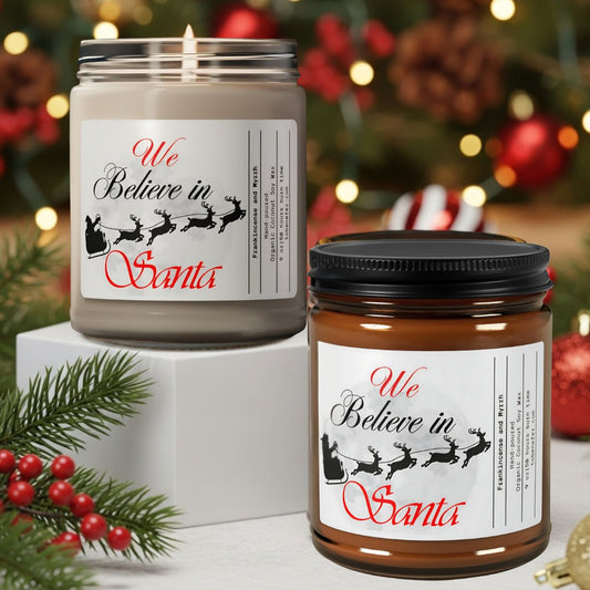 Two candles with 'We Believe in Santa' labels on a Christmas-themed background