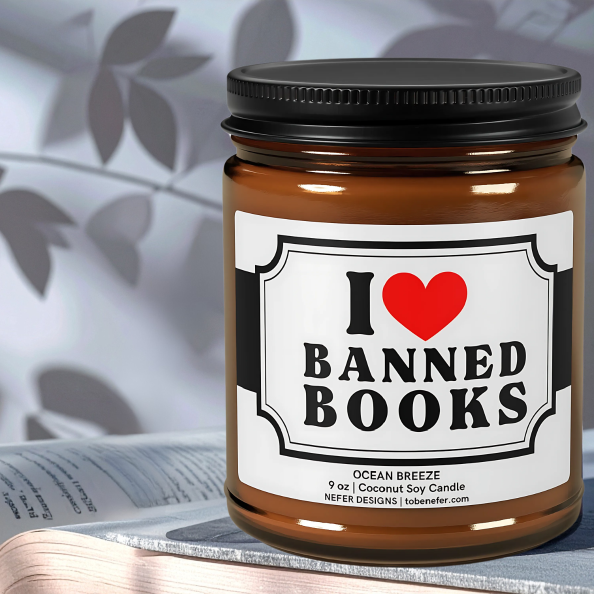 Book lover candle labeled 'I Love Banned Books' placed on the book. 