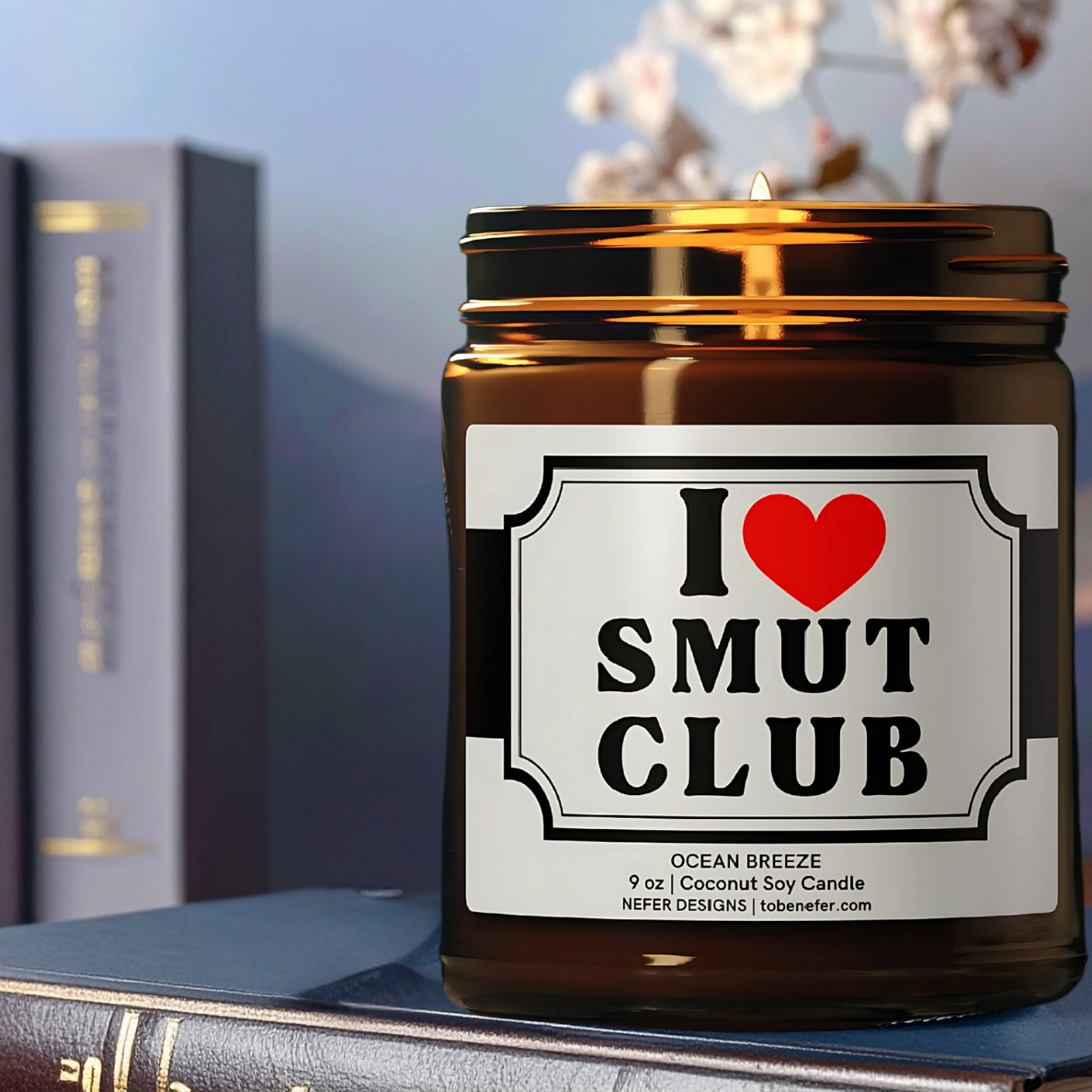 Amber bookish candle glowing in a cozy reading corner – scented candle for spicy romance novels